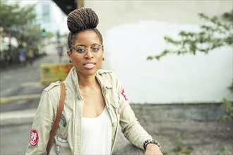 Serious African American woman with braids wearing eyeglasses