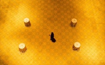 High angle view of woman walking on gold floor