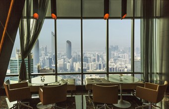 Restaurant tables overlooking Abu Dhabi cityscape