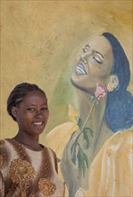 Black woman smiling near mural