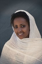 Smiling Black woman wrapped in scarf