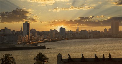 Sunset over high rise buildings in Havana cityscape