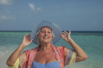 Older Caucasian woman smiling on beach