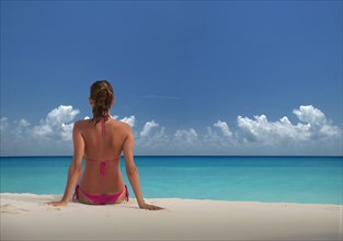 Caucasian woman relaxing on beach