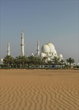 Ornate domed building in desert sand dunes