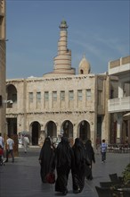Women in hijab walking in Doha square