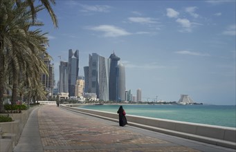 Woman walking on Doha waterfront