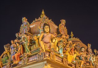 Low angle view of statues on ornate temple dome