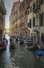 Gondoliers sailing on Venice canal