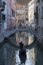 Gondolier sailing on Venice canal