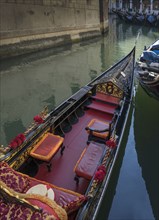 Empty gondola sailing on Venice canal