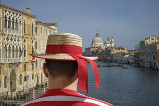 Caucasian gondolier admiring Venice cityscape