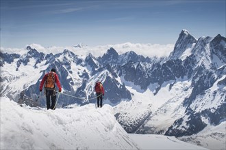 Caucasian skiers walking on mountaintop