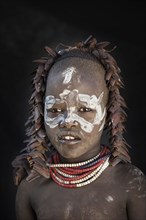 Black teenage girl wearing traditional face paint