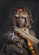 Black mother and daughter wearing traditional jewelry
