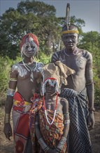 Black father and teenage children in traditional clothing