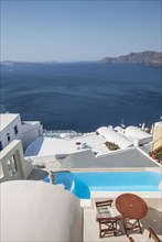 Rooftop swimming pool over Santorini bay