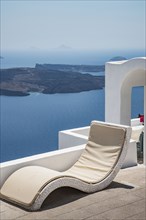 Lawn chair on hilltop overlooking ocean