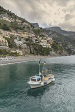 Boat sailing near Positano cityscape