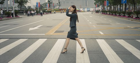 Chinese businesswoman in pedestrian crossing