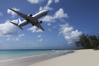 Airplane flying over tropical beach