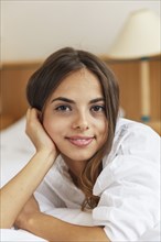 Caucasian woman smiling in bed