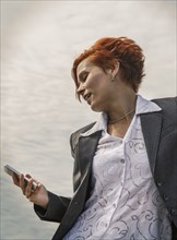 Caucasian businesswoman using cell phone