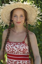 Caucasian woman wearing straw hat