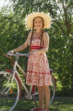 Caucasian woman standing with bicycle