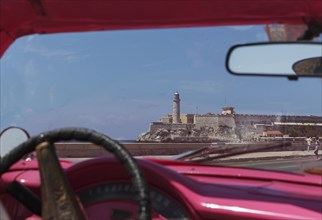 Car driving in Havana cityscape