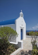 Traditional church entrance and walkway under blue sky