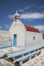 Traditional church entrance and walkway under blue sky