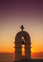 Bell arch with cross and sunset sky