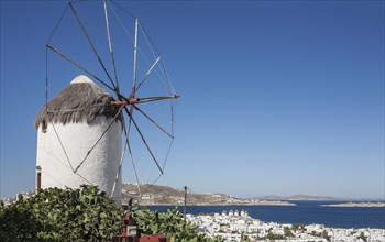 Traditional windmill and Mykonos cityscape