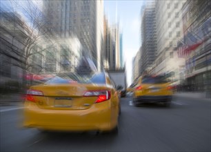 Blurred view of taxis driving on New York street