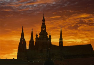 Silhouette of ornate church against sunset sky