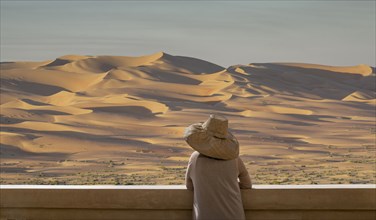 Caucasian woman admiring sand dunes in desert landscape