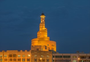 Islamic Cultural Center spire illuminated at night