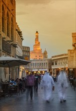 Blurred view of people walking on Doha street