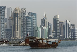Boat floating near Doha skyline