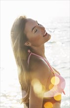 Caucasian woman in pink bikini at beach