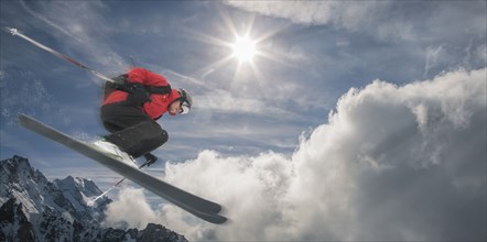 Caucasian skier jumping mid-air on mountain