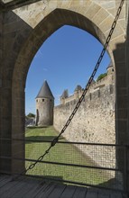 Arch behind gate at castle in Carcassonne