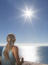 Caucasian woman admiring scenic view of ocean