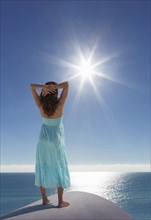 Caucasian woman admiring scenic view of sunny ocean