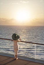 Caucasian woman on boat admiring sunset