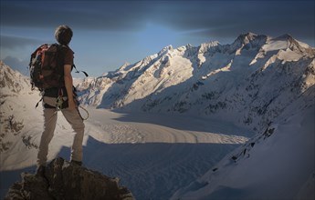 Caucasian man hiking on snowy mountain