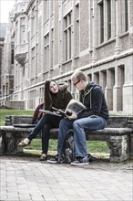 Students sitting on bench together