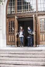 Students coming out of college doorway