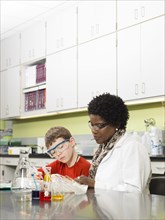 Student and teacher working in chemistry lab